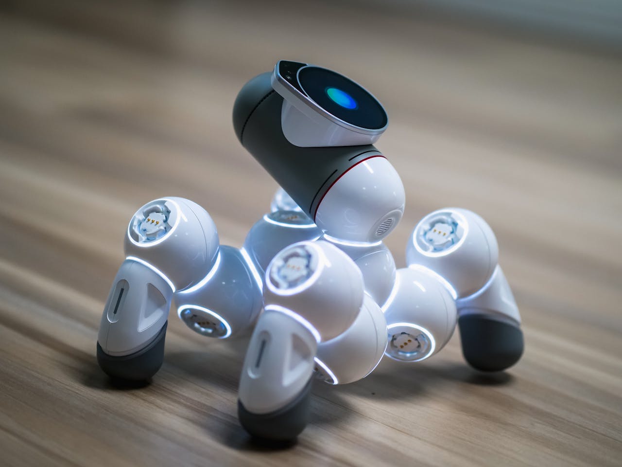 Close-up of a futuristic robot toy on a wooden floor, showcasing modern innovation.